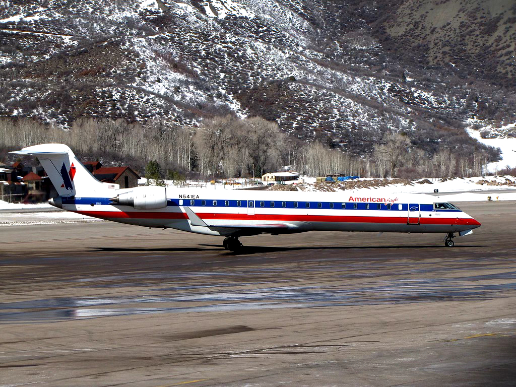 A Bombardier CRJ-700 jet on the runway at Aspen Airport.