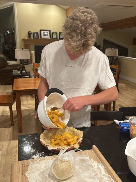 Yale Gieszl crafts a peach pie in preparation for a Thanksgiving meal.