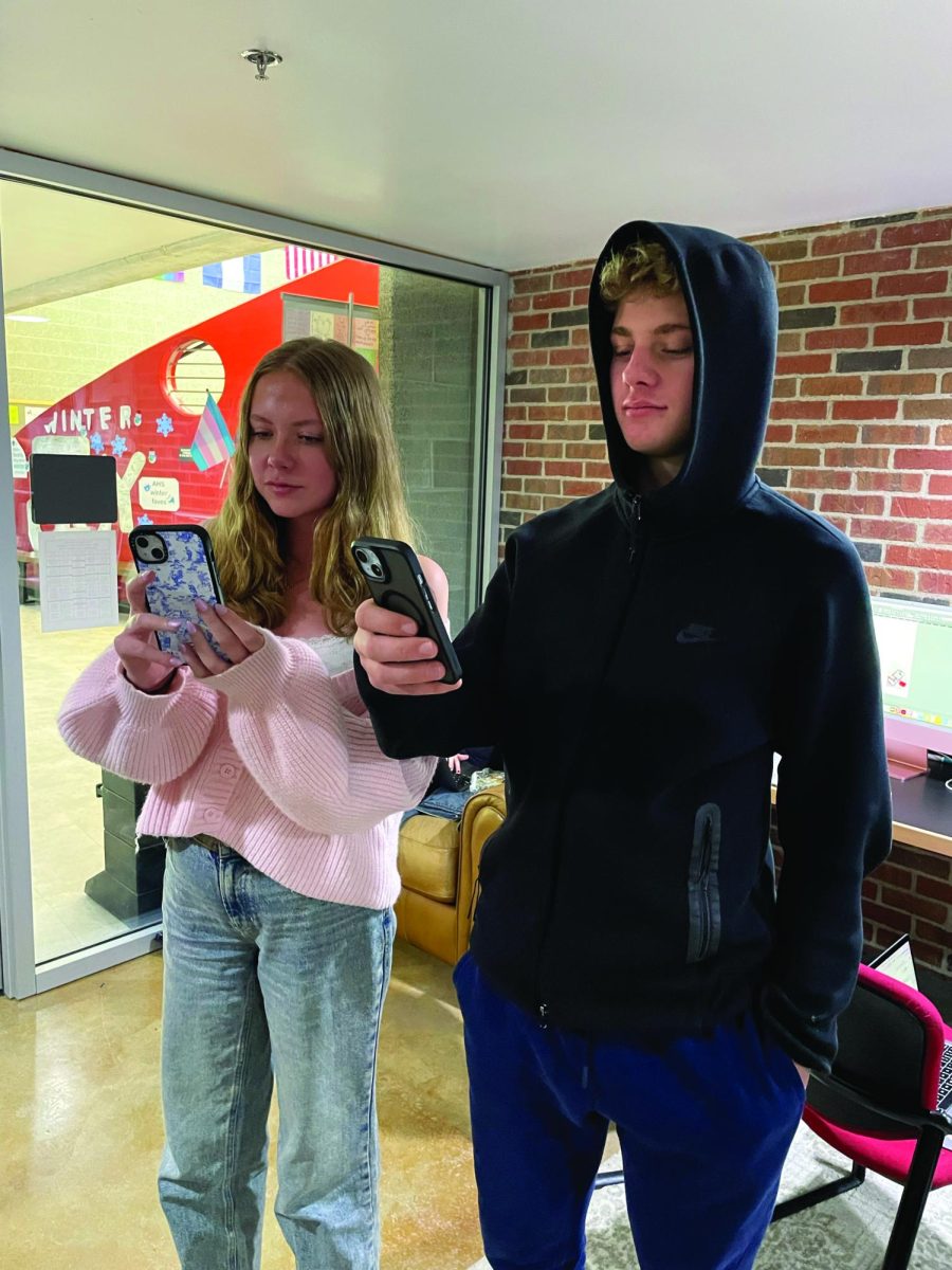 Yale Gieszl (right) and Eleanor Carroll (left) absorbed in Snapchat.