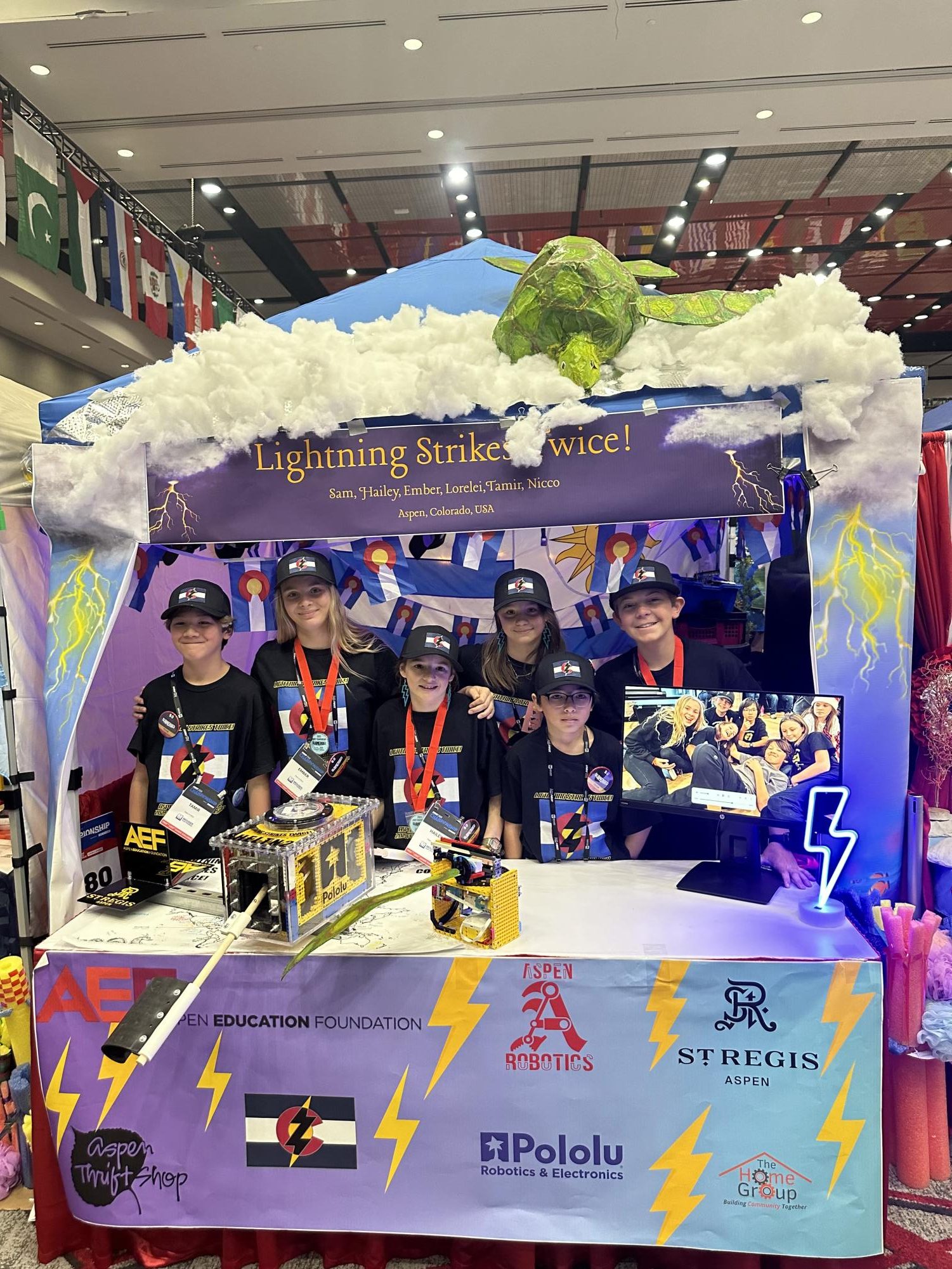 The team poses in front of their pit at Worlds in Houston, TX on April 16, 2025.