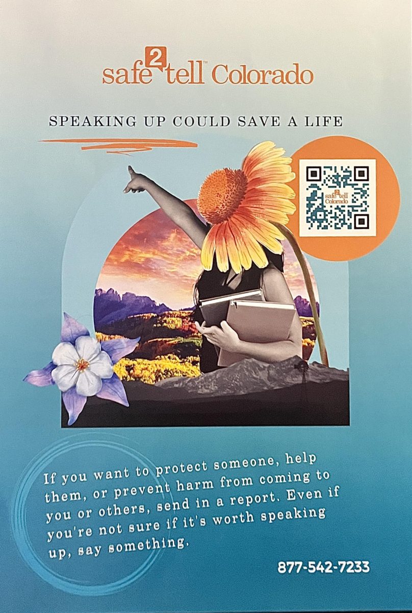 A Safe2Tell poster displayed in the womens restroom at AHS with a QR code and phone number for contact.