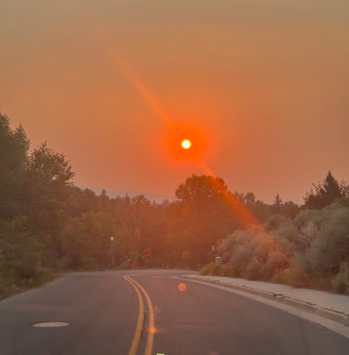 On August 10, 2025, an intense, smoky-red sun cast red glow over a road in Aspen, Colorado. The smoke was blowing in all the way from the Lee fire, 109 miles away.
