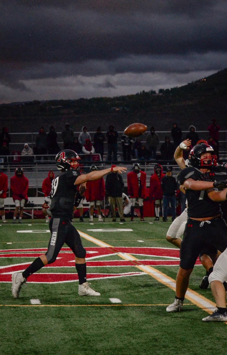 AHS junior and quarterback of the football team, Mickey Marolt, throws the ball to his teammates. 