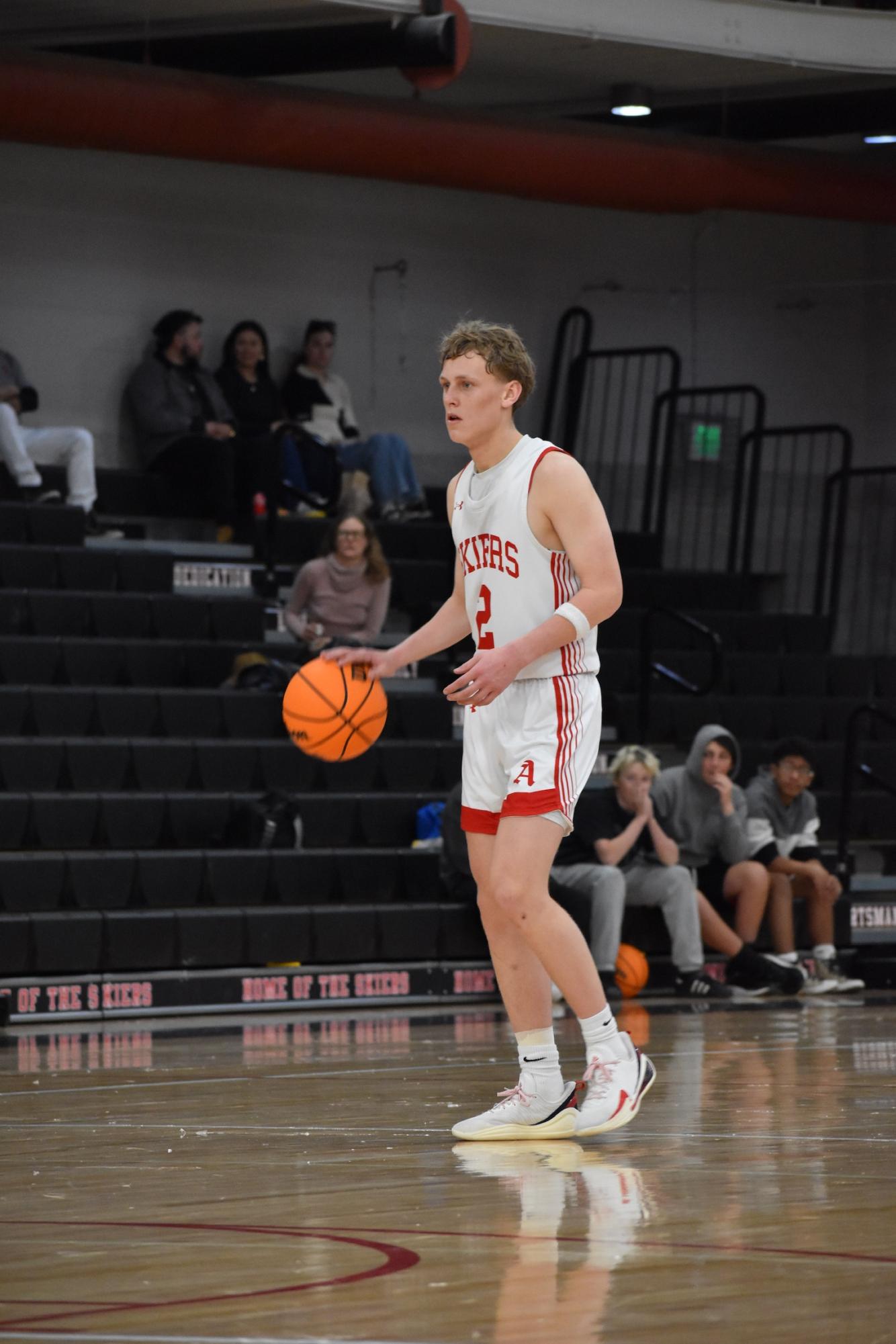 Current senior Kristo Klavins dribbles the basketball during the Skier's contest vs Timnath on March 8, 2025. Klavins and the Skiers will return to the gym on 1/16 for a game against Steamboat. 