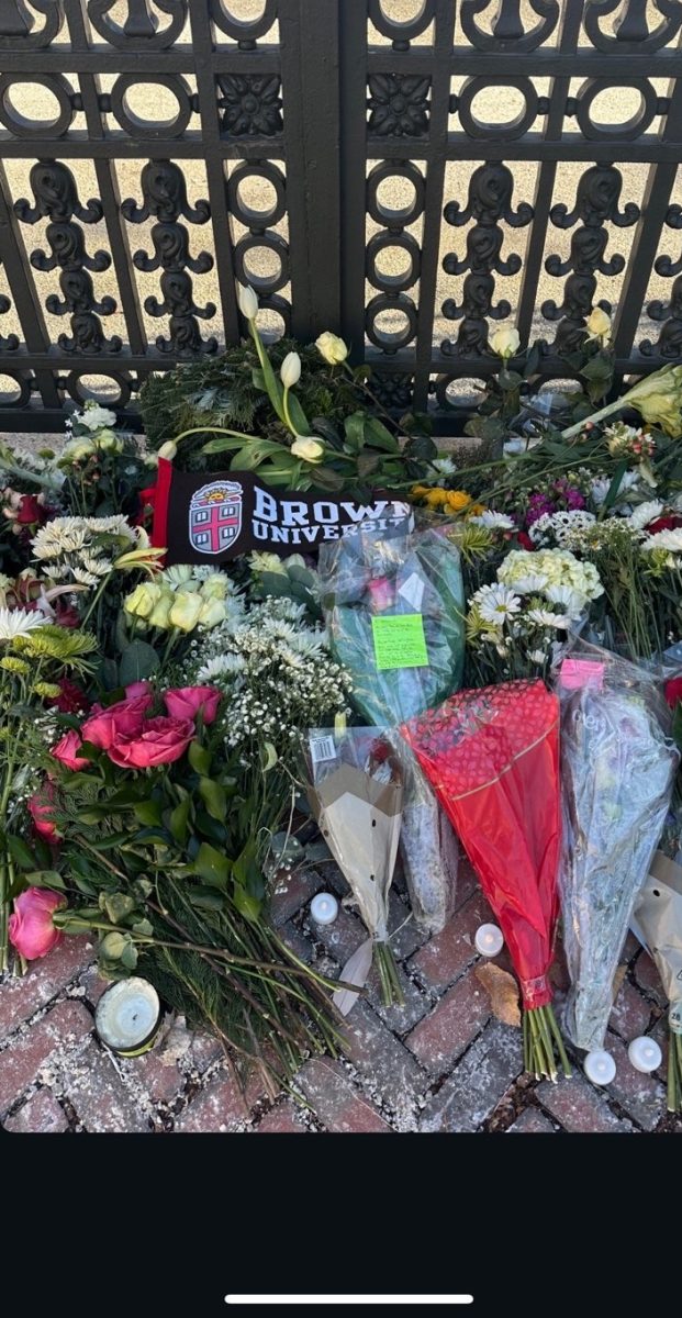 Flowers lay at a gate on Brown University's campus to mourn the victims of the shooting on Dec. 13.