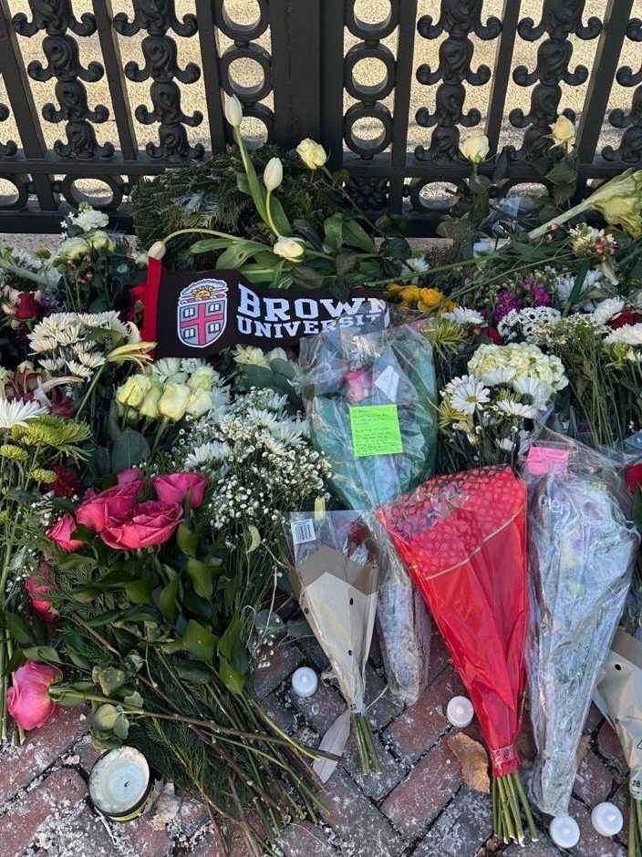 Flowers lay at a gate on Brown University's campus to mourn the victims of the shooting on Dec. 13.