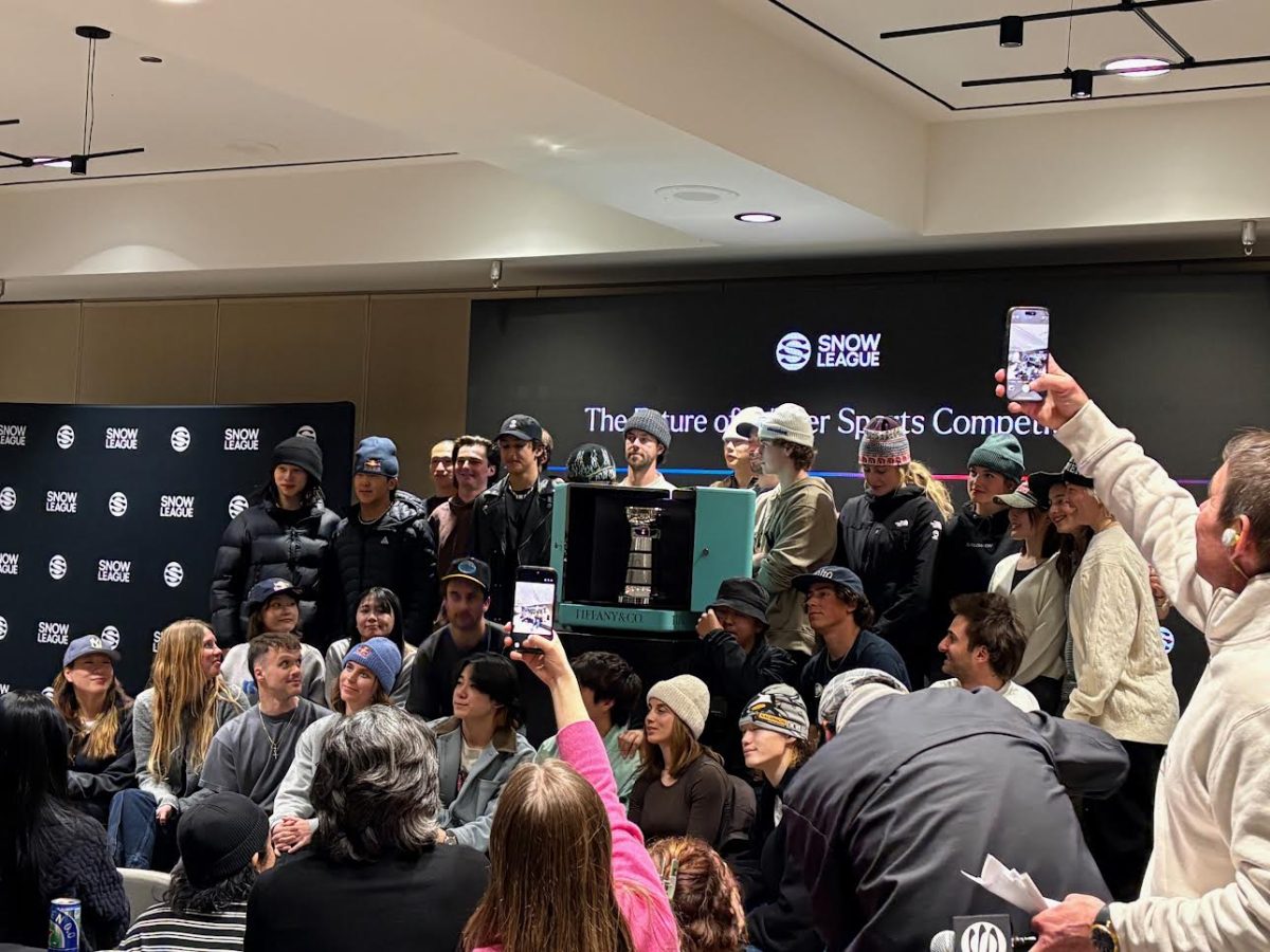 Athletes competing in Snow League stand with a newly unveiled trophy at a pre-event called The Draw. 