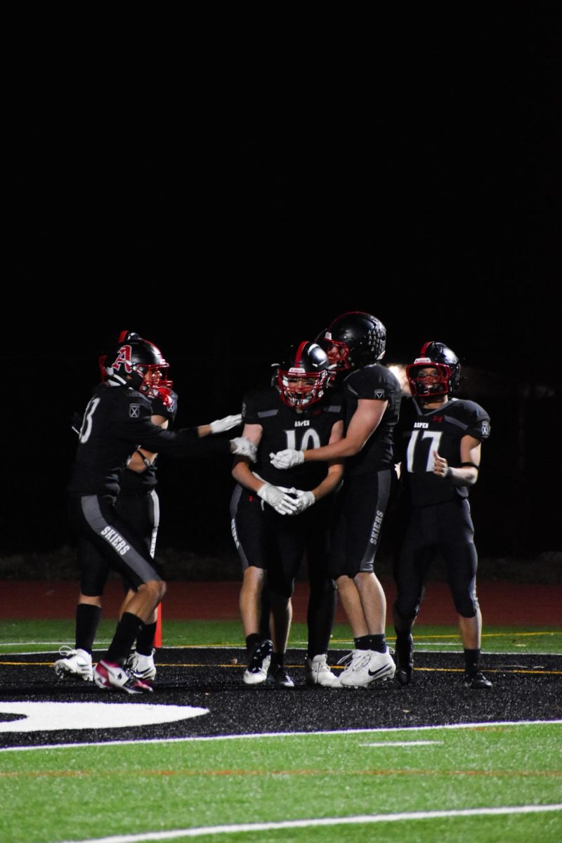 AHS football players celebrate a touchdown as a team during their homecoming victory against Moffat County High School. 