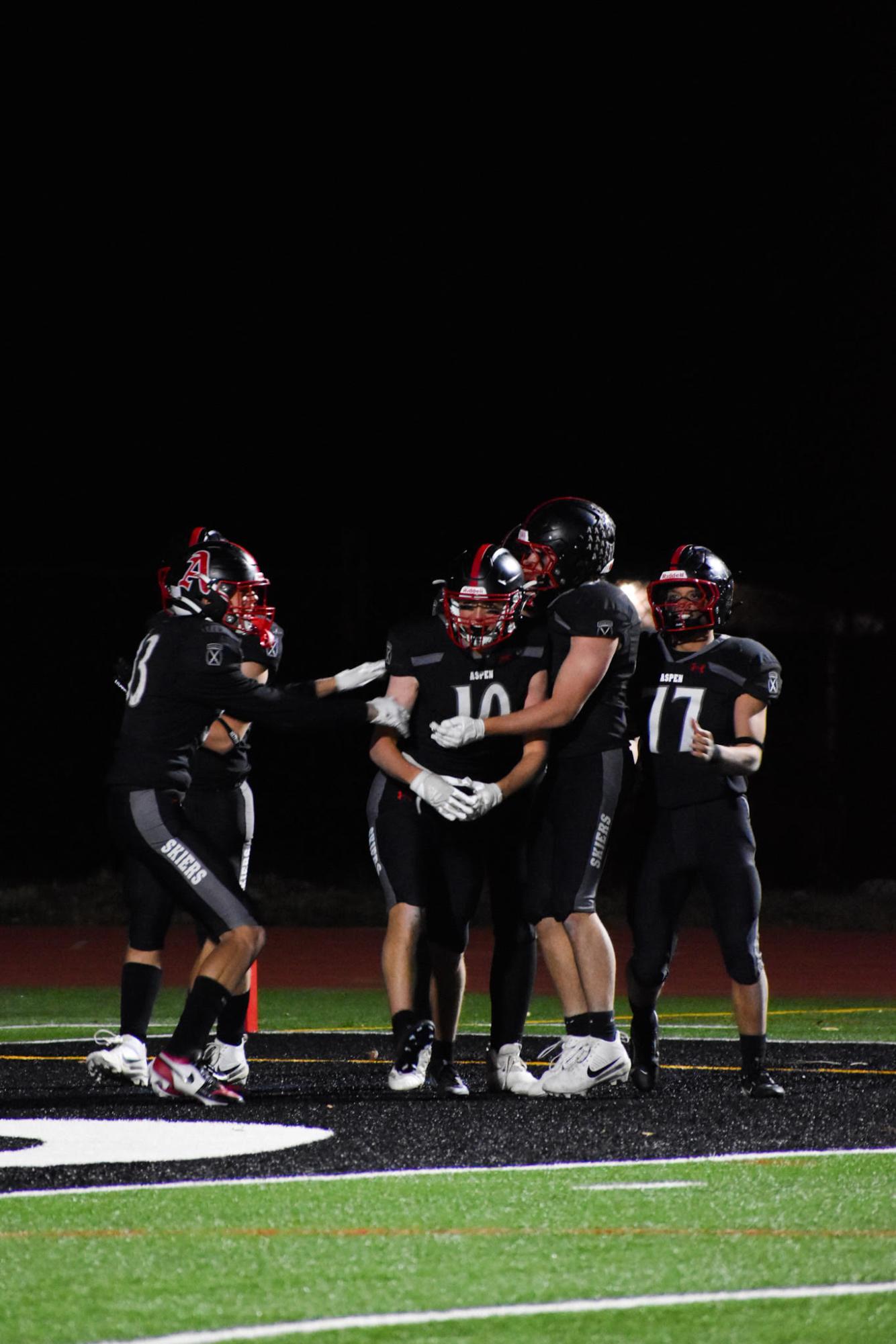 AHS football players celebrate a touchdown as a team during their homecoming victory against Moffat County High School. 