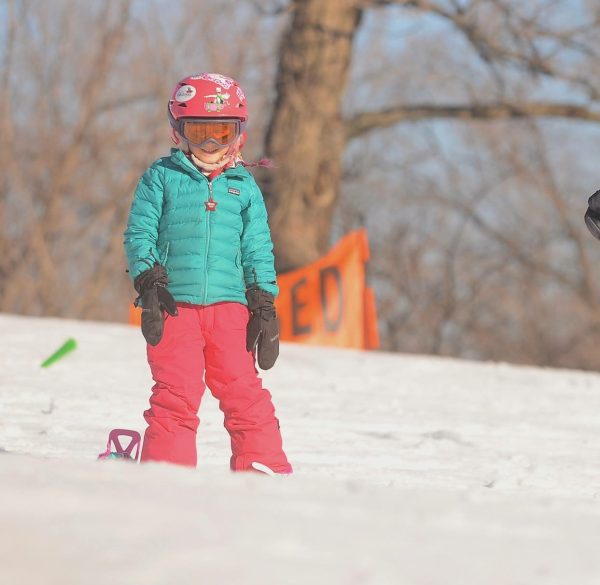 A young Sloane Alexander stands at the top of a run on Snowmass. She would later purchase a bag of Skittles and eat them on the Sky Cab.